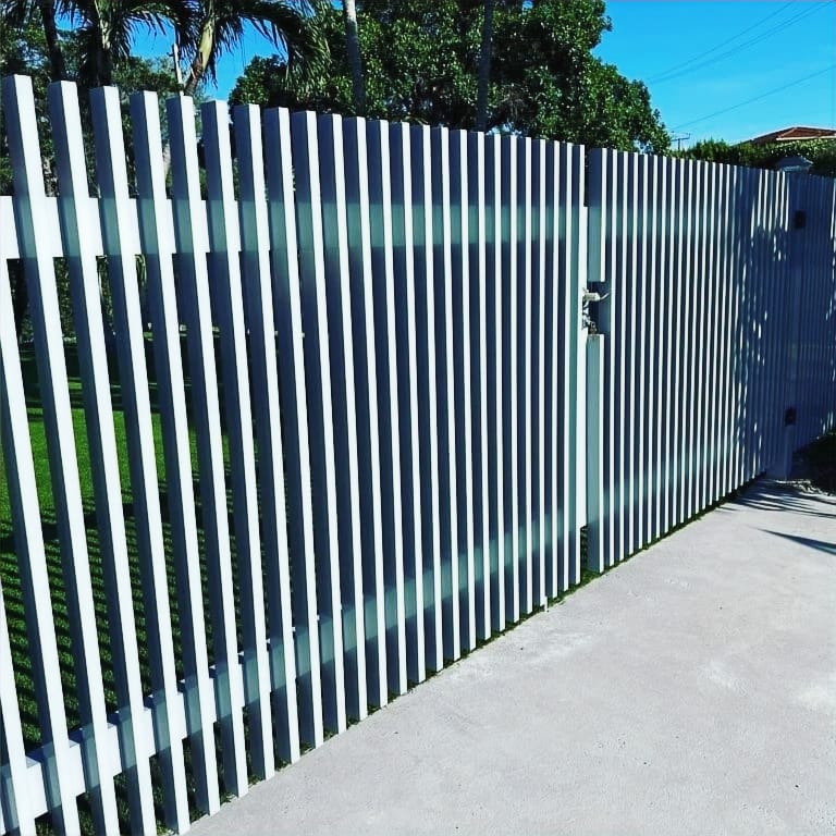 Black aluminum picket pool-code fence around a Miami residential pool