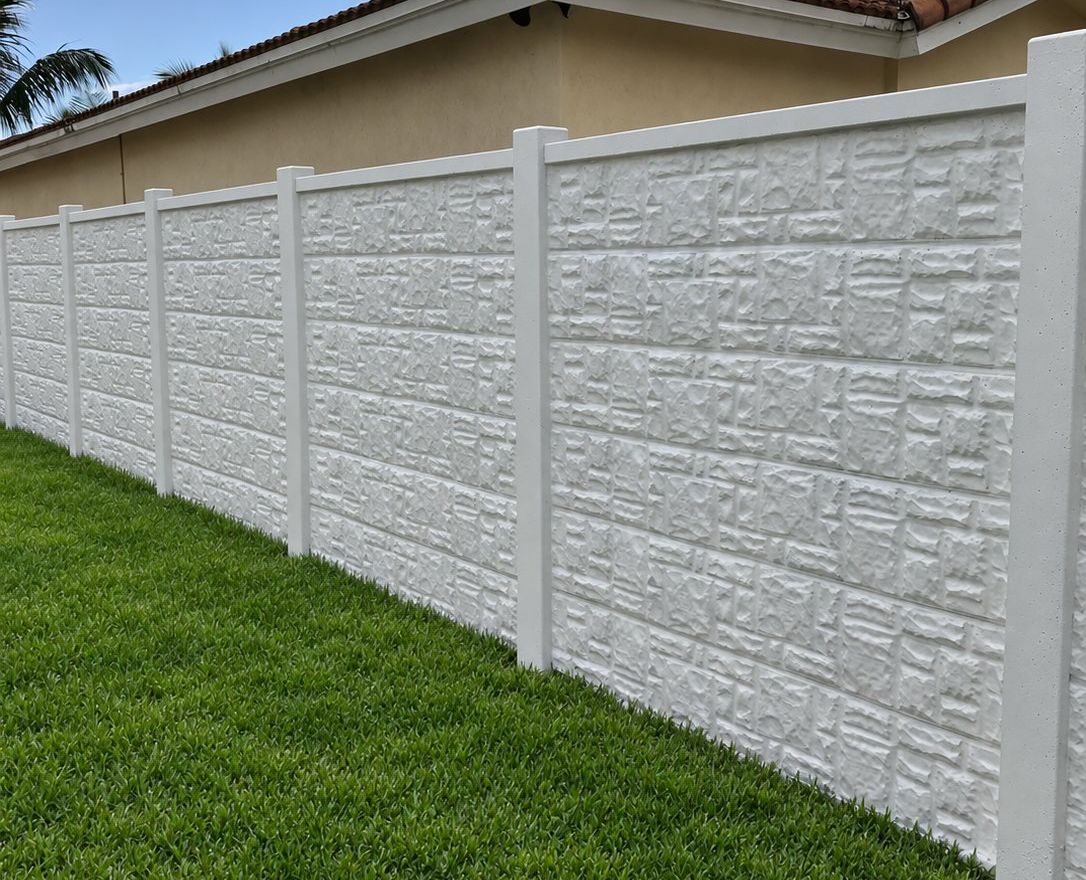 Precast concrete perimeter wall with a cast stone face, installed and painted by Allday Fence